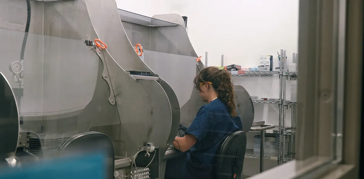 Operators at enclosed workstations in a controlled production area